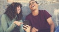 Latin american young adult couple watching clip online at mobile phone Royalty Free Stock Photo