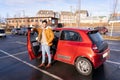 Latin or arab man standing near car with opened door on parking slot of city