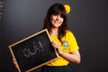 Latin brazil lady in a soccer clothes holding a small blackboard with Hello word on his native language isolated on gray