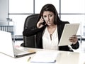 Latin business woman suffering stress working at office computer desk worried