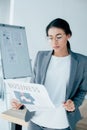 Latin businesswoman in glasses reading business newspaper in office Royalty Free Stock Photo