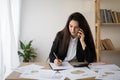Latin businesswoman talking on the phone and taking notes working in office. Business Royalty Free Stock Photo