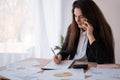 Latin businesswoman talking on the phone and taking notes working in office. Business Royalty Free Stock Photo