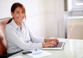 Latin businesswoman working with her laptop