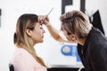 Latin Cosmetologist preparing to mexican woman for eyebrow permanent makeup procedure in Mexico, Microblading closeup