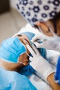 Latin Cosmetologist preparing to mexican woman for eyebrow permanent makeup procedure in Mexico, Microblading closeup