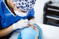 Latin Cosmetologist preparing to mexican woman for eyebrow permanent makeup procedure in Mexico, Microblading closeup