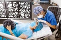 Latin Cosmetologist preparing to mexican woman for eyebrow permanent makeup procedure in Mexico, Microblading closeup