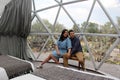 Latin couple in love inside glamping dome room with desert vegetation outside