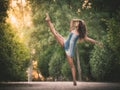 Latin dancer with leg raised in road full of vegetation Royalty Free Stock Photo