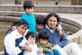 Latin family sitting in the street Royalty Free Stock Photo