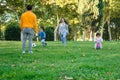 Latin family with two children playing soccer and with balance bike. Royalty Free Stock Photo