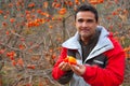 Latin farmer in autumn with persimmon fruits