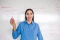 Latin Female school teacher looks at camera in classroom speaking virtual teaching remote class, online lesson, e-learning video Royalty Free Stock Photo