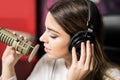 Latin female singer singing at radio station