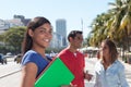 Latin female student with friends in the city Royalty Free Stock Photo