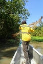 Latin Fisherman casting his net from the boat Royalty Free Stock Photo