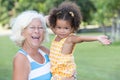 Latin girl and her caucasian grandmother hugging in a park Royalty Free Stock Photo