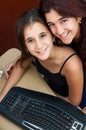 Latin girl and her mother working on a computer Royalty Free Stock Photo