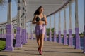 Latin girl runs by a pergola in a park Royalty Free Stock Photo