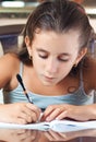 Latin girl working on her homework Royalty Free Stock Photo