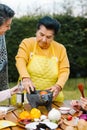 Latin grandmother and granddaughter, daughter cooking mexican food at home, three generations of women in Mexico Royalty Free Stock Photo