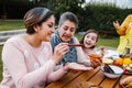 Latin grandmother and granddaughter, daughter cooking mexican food at home, three generations of women in Mexico Royalty Free Stock Photo