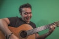 Latin happy guy playing guitar Royalty Free Stock Photo