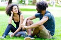 Latin Hipster couple sitting on meadow Royalty Free Stock Photo