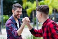 Latin hipster young adult giving high five to friend