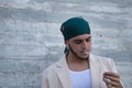 Latin and Hispanic boy, young and nonconformist, rebellious, with a handkerchief on his head, exhaling the smoke of a cigarette