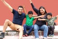 Latin, Hispanic family of mom, dad and children are sitting in the park they look happy enjoying quality time together in harmony Royalty Free Stock Photo