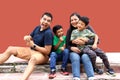 Latin, Hispanic family of mom, dad and children are sitting in the park they look happy enjoying quality time together in harmony Royalty Free Stock Photo