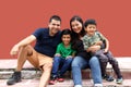 Latin, Hispanic family of mom, dad and children are sitting in the park they look happy enjoying quality time together in harmony Royalty Free Stock Photo