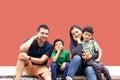 Latin, Hispanic family of mom, dad and children are sitting in the park they look happy enjoying quality time together in harmony Royalty Free Stock Photo