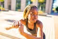Latin hispanic girl with long yellow dreadlocks pigtails working out outdoor in ste streets in sity down town Royalty Free Stock Photo