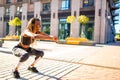 Latin hispanic girl with long yellow dreadlocks pigtails working out outdoor in ste streets in sity down town Royalty Free Stock Photo