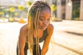 Latin hispanic girl with long yellow dreadlocks pigtails working out outdoor in ste streets in sity down town Royalty Free Stock Photo