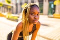 latin hispanic girl with long yellow dreadlocks pigtails working out outdoor in ste streets in sity down town Royalty Free Stock Photo