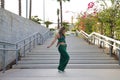 Latin and Hispanic girl, young and beautiful, dancing modern dance in the street outdoors. Dance concept, moonwalk, jumpstyle,