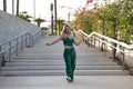 Latin and Hispanic girl, young and beautiful, dancing modern dance in the street outdoors. Dance concept, moonwalk, jumpstyle,