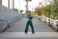 Latin and Hispanic girl, young and beautiful, dancing modern dance in the street outdoors. Dance concept, moonwalk, jumpstyle, Royalty Free Stock Photo