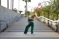 Latin and Hispanic girl, young and beautiful, dancing modern dance in the street outdoors. Dance concept, moonwalk, jumpstyle, Royalty Free Stock Photo