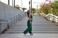 Latin and Hispanic girl, young and beautiful, dancing modern dance in the street outdoors. Dance concept, moonwalk, jumpstyle,