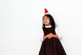 Latin little girl with elegant party dress and Christmas hat dances with happiness for the arrival of December and celebrate Chris Royalty Free Stock Photo