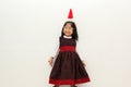 Latin little girl with elegant party dress and Christmas hat dances with happiness for the arrival of December and celebrate Chris Royalty Free Stock Photo