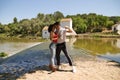 latin loving couple dancing social dance, kizomba, taraxia bachata, semba in the park next to the river and some big trees. Dance Royalty Free Stock Photo