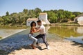 latin loving couple dancing social dance, kizomba, taraxia bachata, semba in the park next to the river and some big trees. Dance