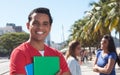 Latin male student with friends in the city Royalty Free Stock Photo