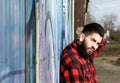 Latin man with beard and piercings sitting outdoors Royalty Free Stock Photo